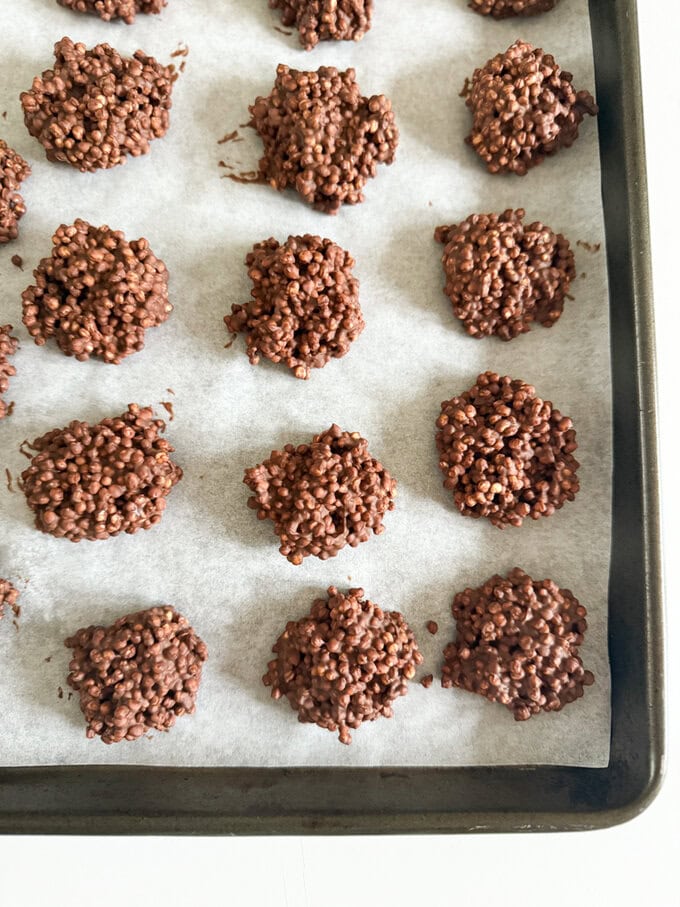 Chocolate Quinoa bites on a baking tray lined with grease proof paper.