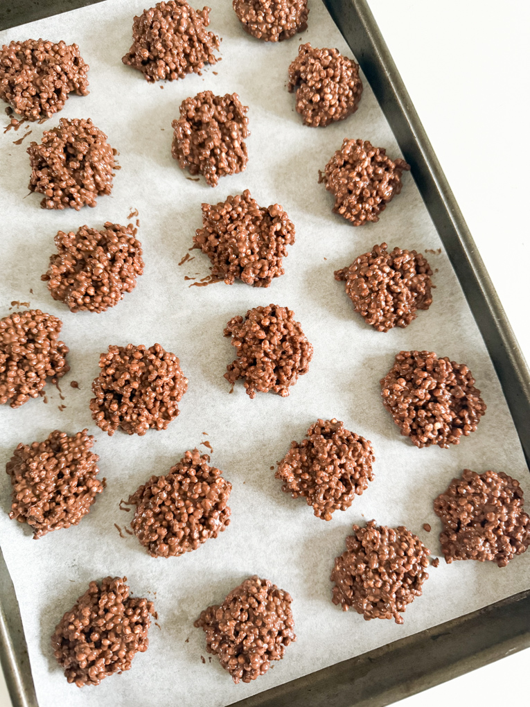 Chocolate Quinoa bites on a baking tray lined with grease proof paper.