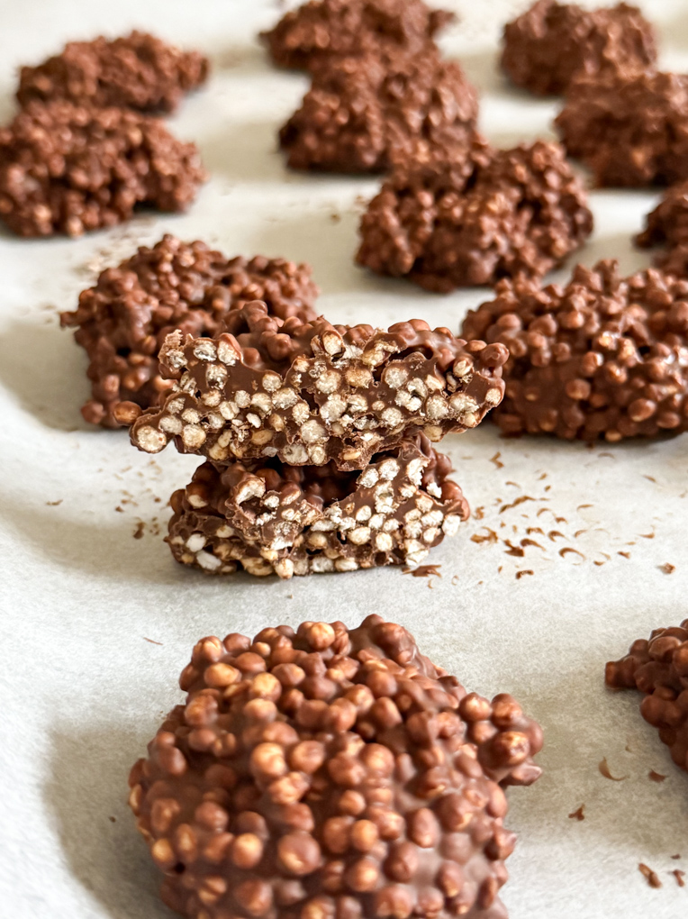 Chocolate Quinoa bites on a baking tray lined with grease proof paper.