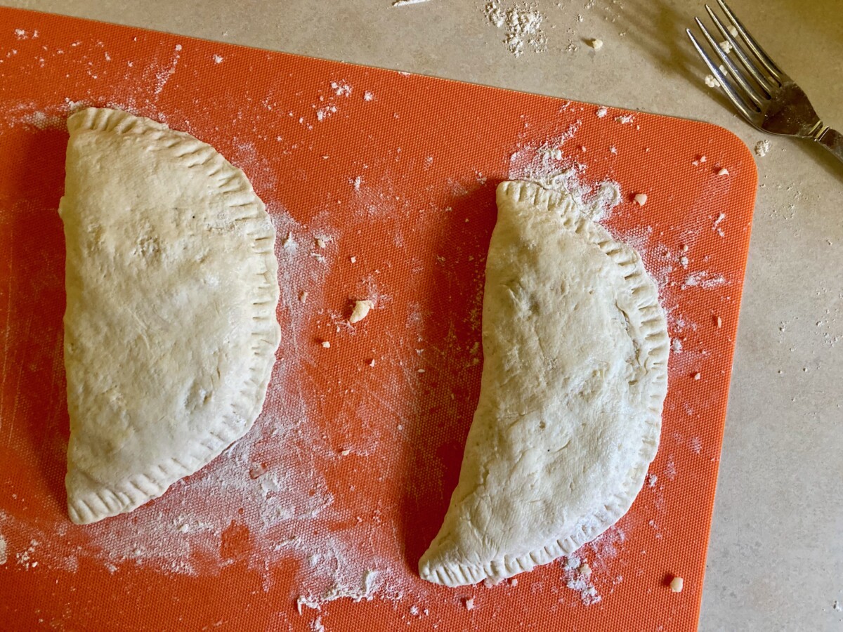 Uncooked bean and cheese empanadas.