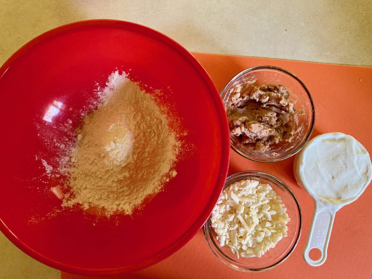 Ingredients including self-rising dough, yogurt, shredded cheese and refried beans.